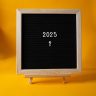 Chalkboard with '2025' on bright yellow background, symbolizing a fresh start to the new year.